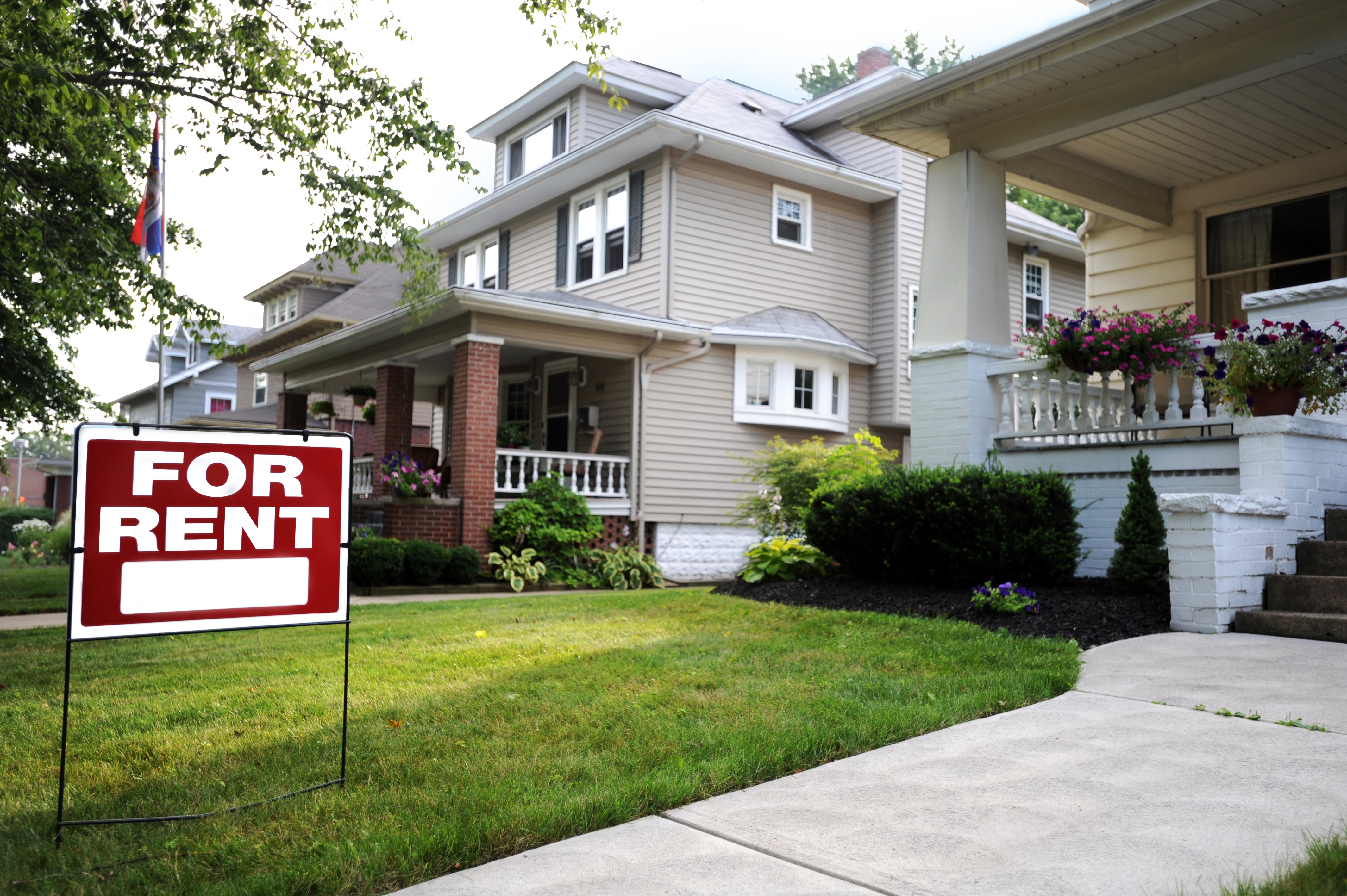 For rent sign in a front yard of a home